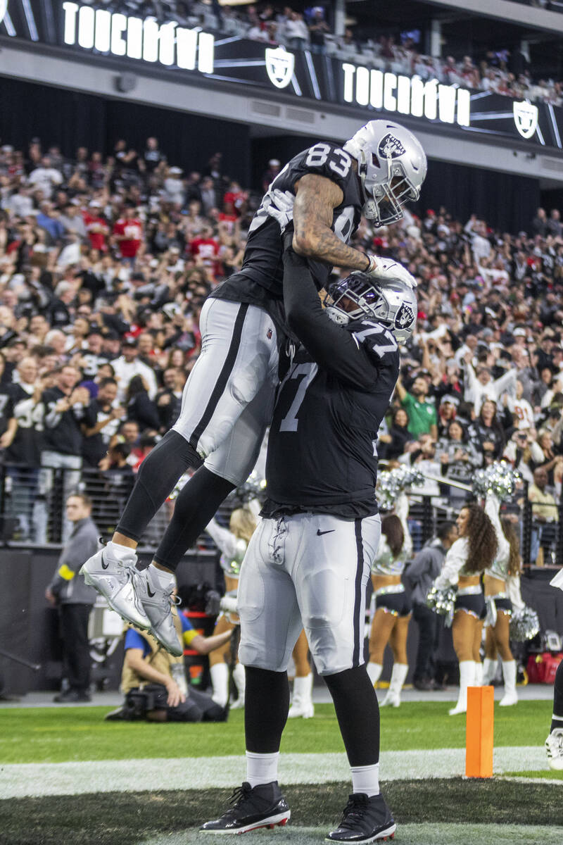 Raiders tight end Darren Waller (83) celebrates his touchdown with offensive tackle Thayer Munf ...