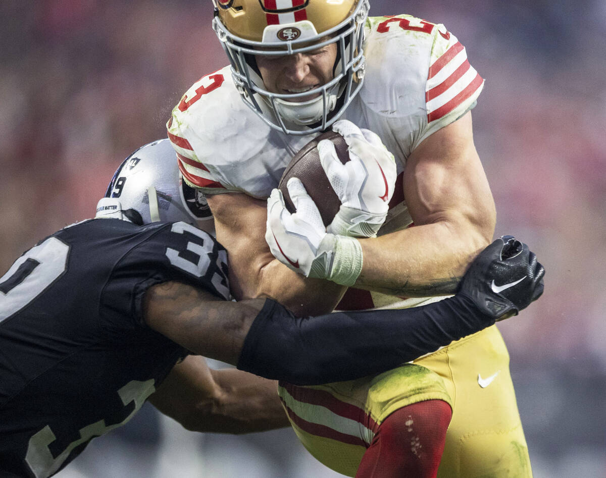 Raiders cornerback Nate Hobbs (39) is in coverage as San Francisco 49ers running back Christian ...