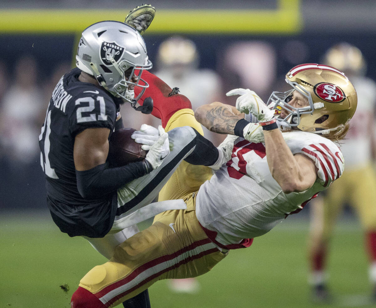 Raiders cornerback Amik Robertson (21) collides as intercepts a pass intended for San Francisco ...