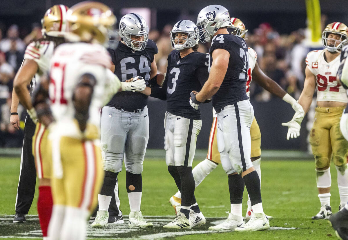 Raiders quarterback Jarrett Stidham (3) is assisted up by teammates guard Alex Bars (64) and of ...