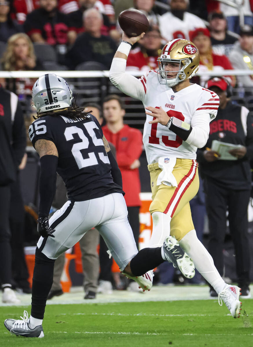San Francisco 49ers quarterback Brock Purdy (13) throws a pass over Raiders safety Tre'von Moeh ...