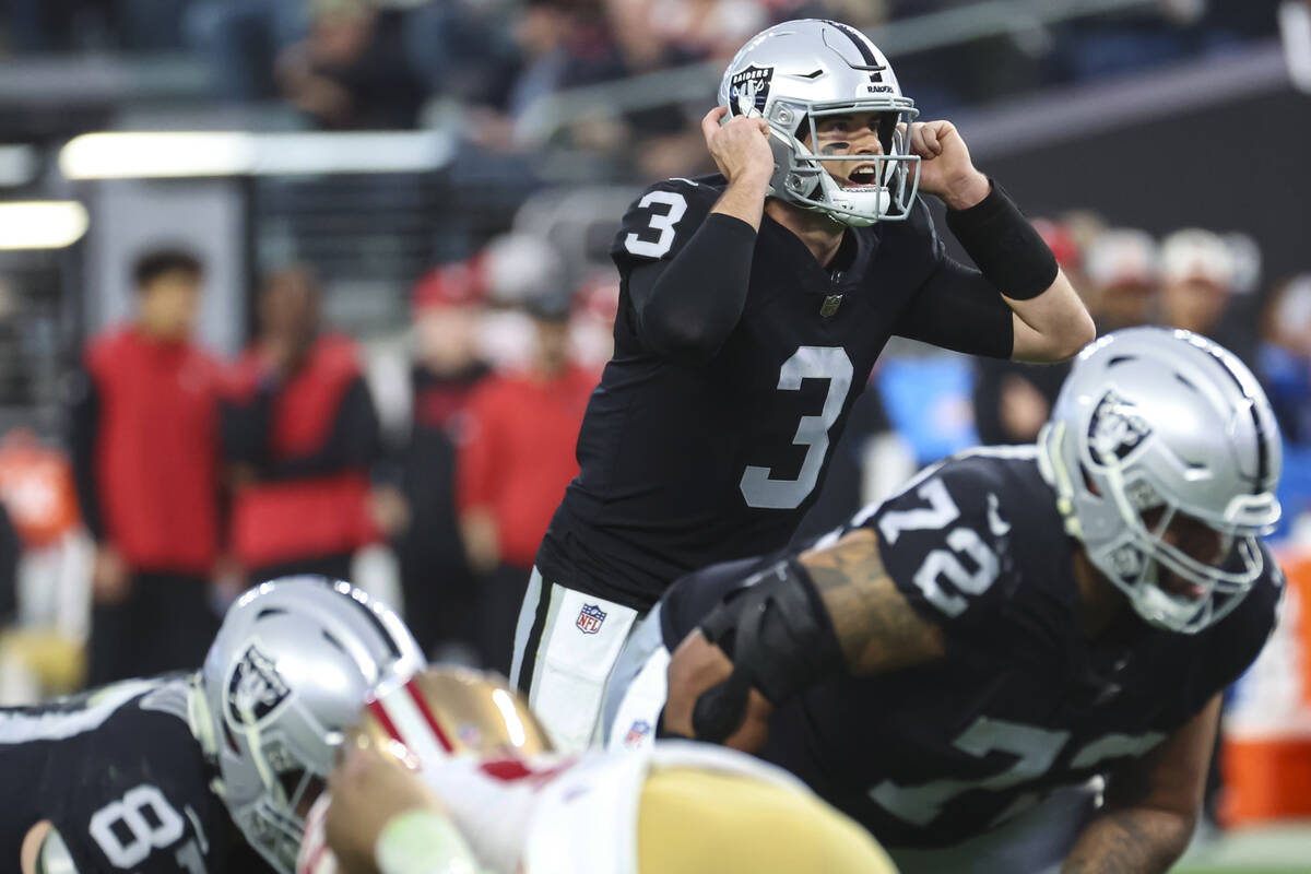 Raiders quarterback Jarrett Stidham (3) motions to teammates during the first half of an NFL ga ...