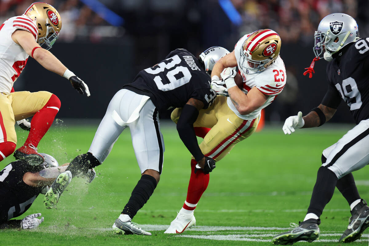 Raiders cornerback Nate Hobbs (39) tackles San Francisco 49ers running back Christian McCaffrey ...