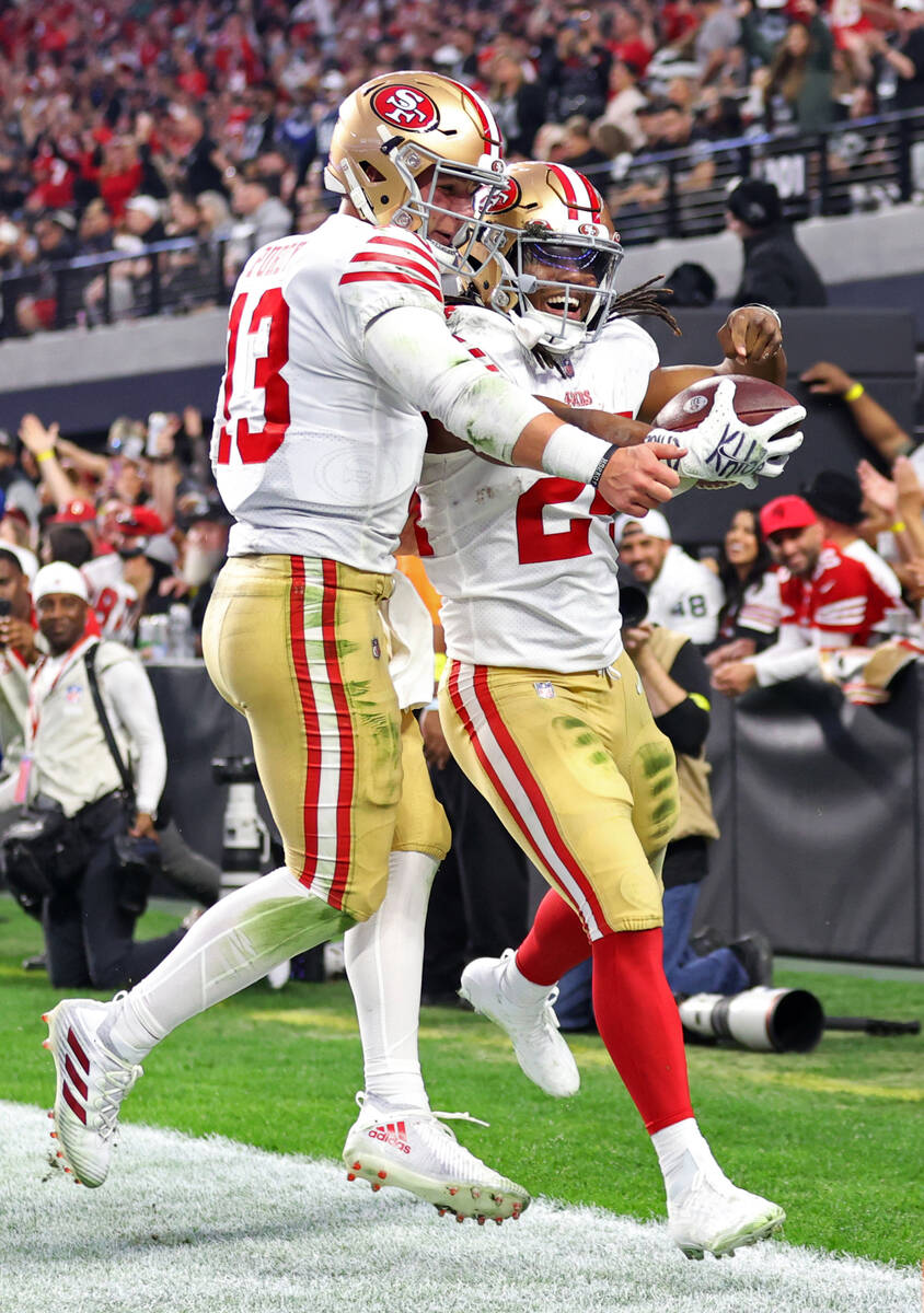 San Francisco 49ers running back Jordan Mason (24) celebrates a touchdown catch with quarterbac ...