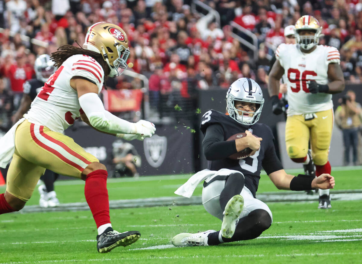Raiders quarterback Jarrett Stidham (3) slides with the ball during the first half of an NFL ga ...