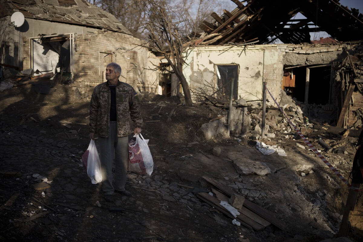 Anatolii Kaharlytskyi, 73, stands near his house, heavily damaged after a Russian attack in Kyi ...