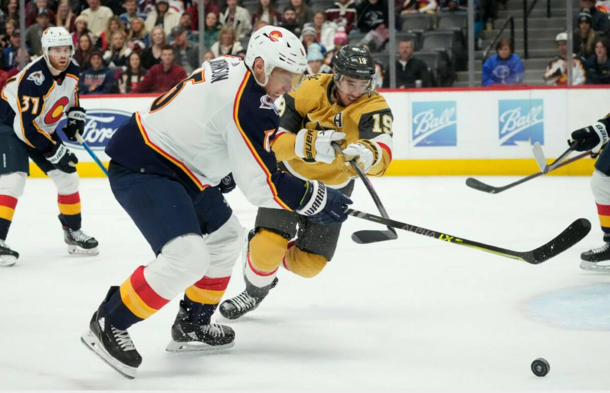 Colorado Avalanche defenseman Erik Johnson, center left, fights for control of the puck with Ve ...