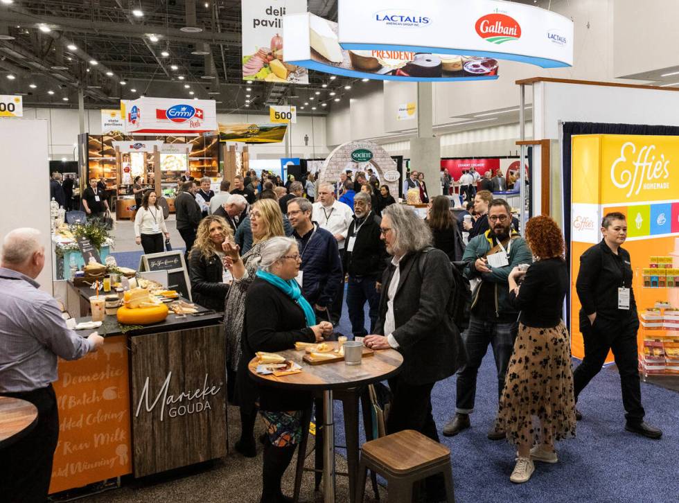 Showgoers check out food products during Fancy Food Show at the Las Vegas Convention Center on ...