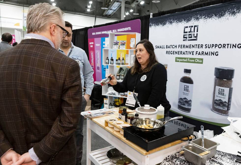 Jessica Saydah of CinSoy Foods, shows one of her products to a potential buyer at CinSoy booth ...