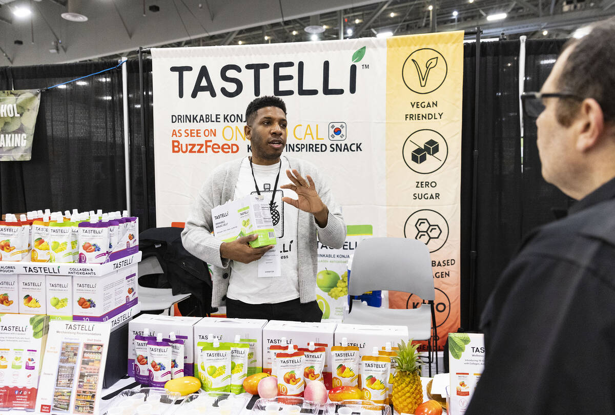 Jet Cessant of J plus Speciality Food, speaks to a potential buyer at Tastelli booth during Fan ...