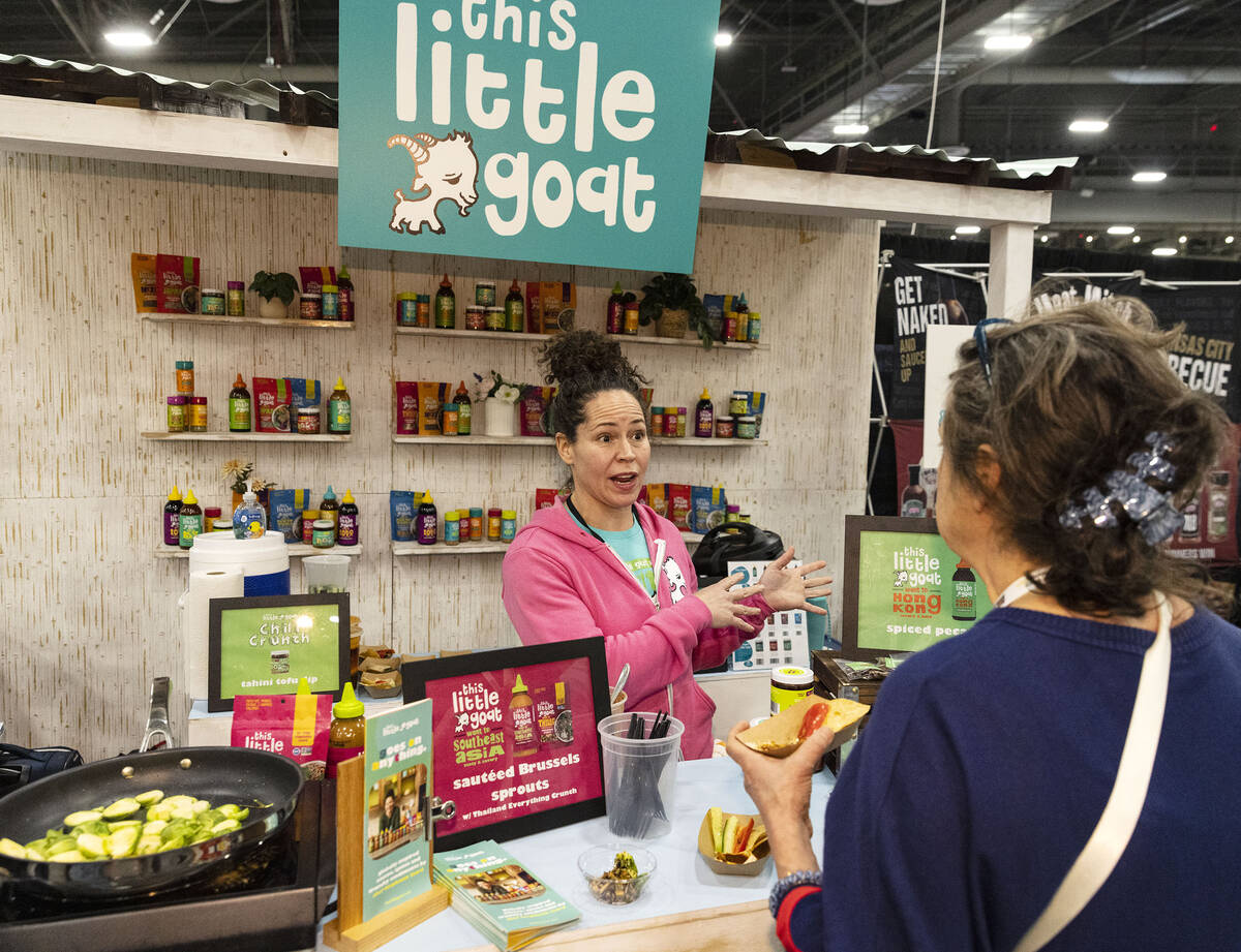 Chef Stephanie Izard talks to a potential buyer at her Little Goat booth during Fancy Food Show ...