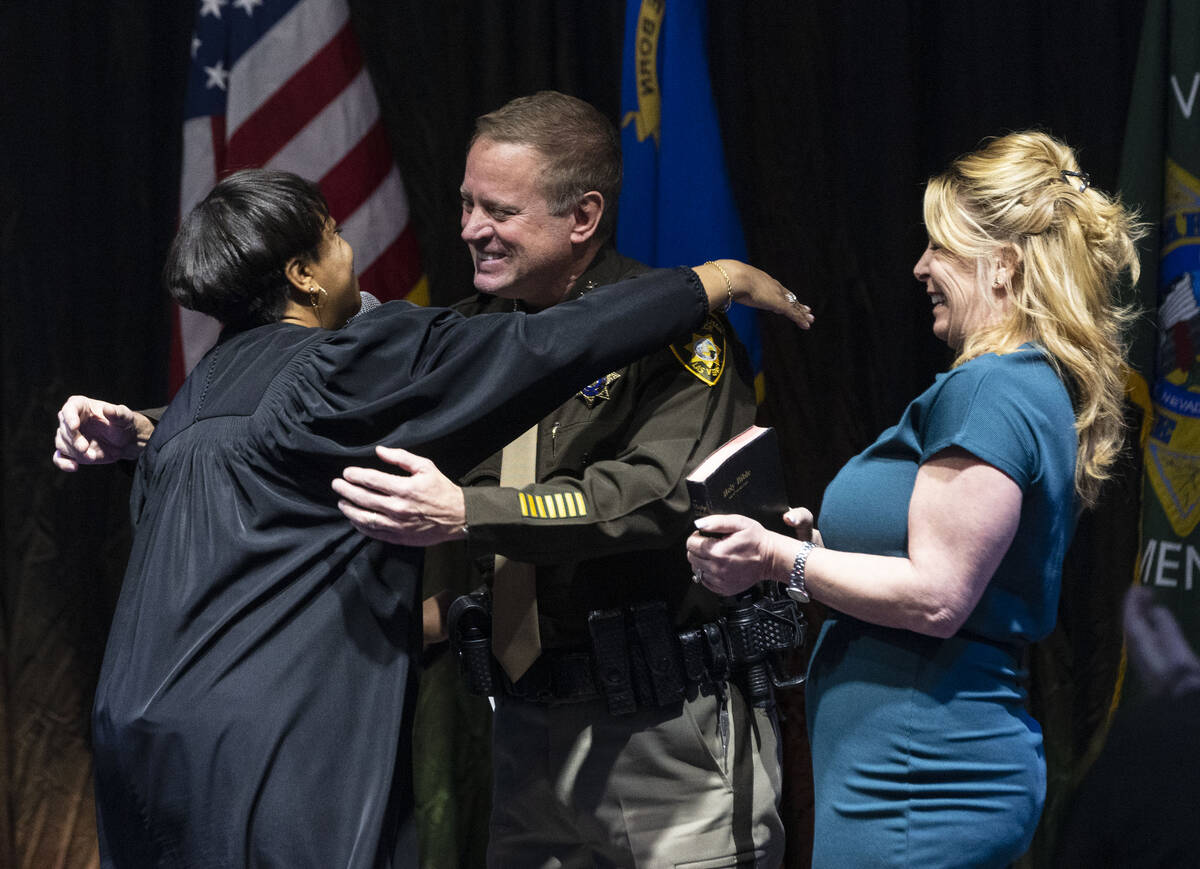 Sheriff Kevin McMahill hugs Judge Tierra Jones after being sworn in as LVMPD Sheriff as his wif ...