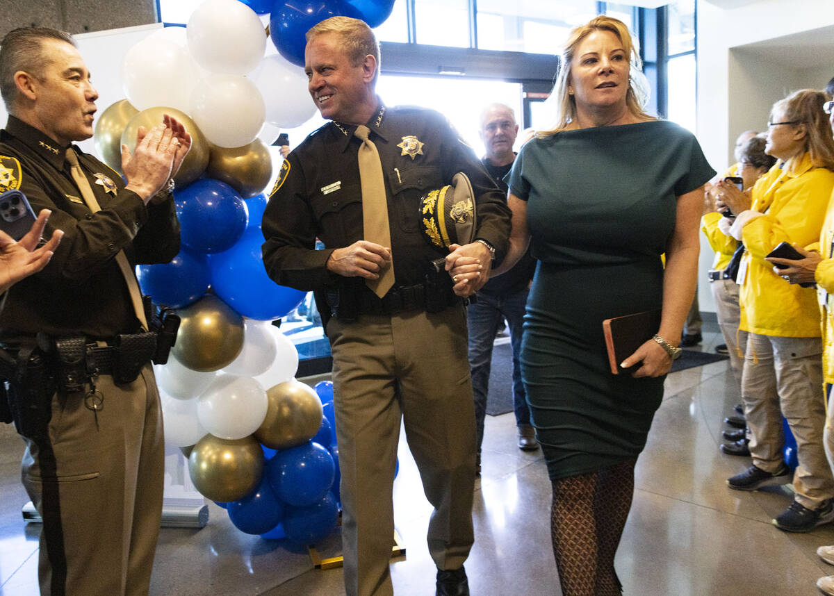 Sheriff-elect Kevin McMahill, left, greeted by Las Vegas police officers and volunteers as he a ...