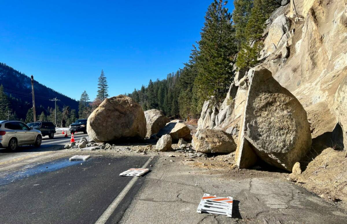 Sveral large boulders lie in the street that fell onto Highway 50 just east of Kyburz during a ...