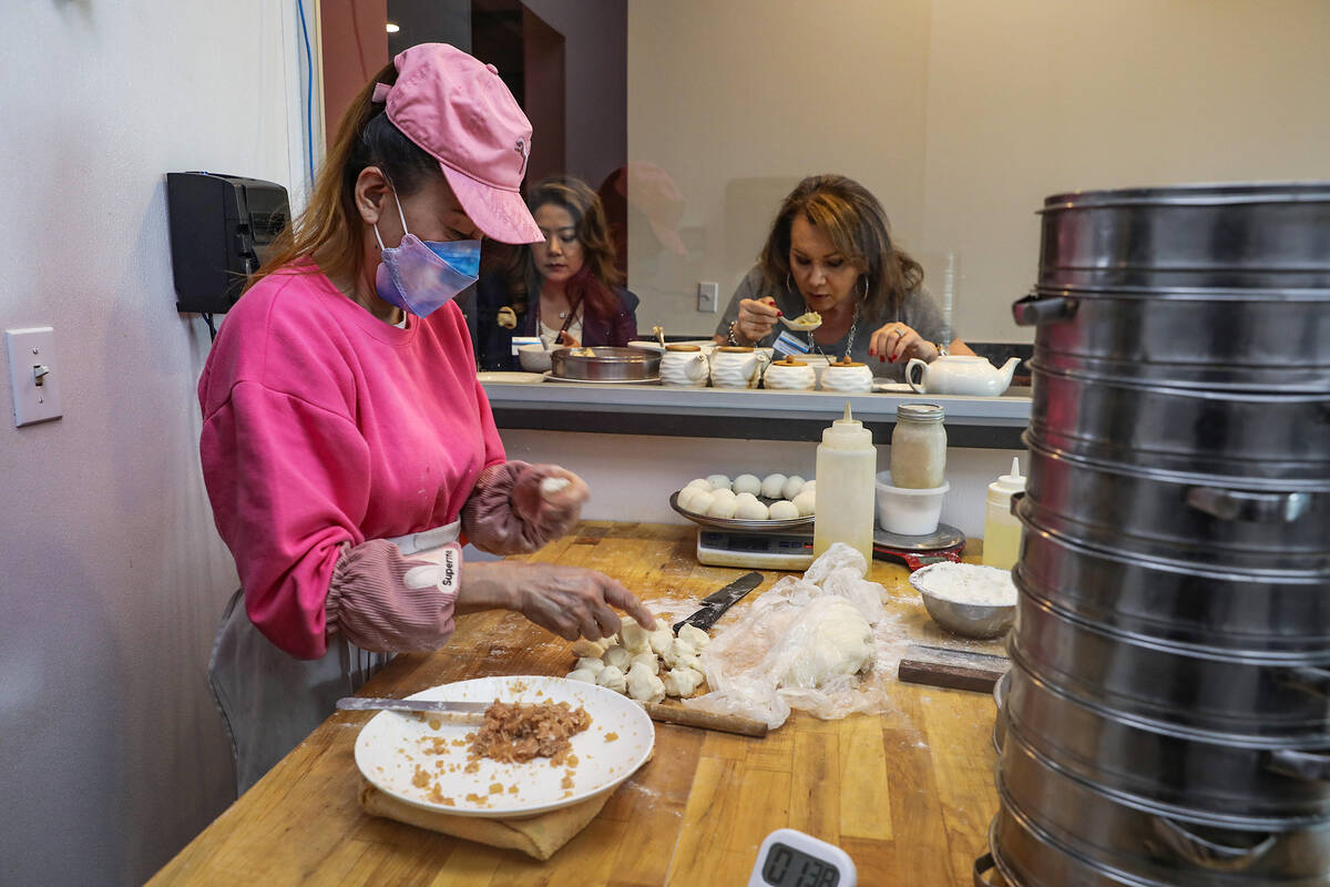 Annie Meiying makes dumplings as guests eat their lunch behind her at ShangHai Taste in Las Veg ...
