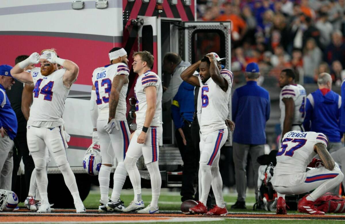 Buffalo Bills players react as teammate Damar Hamlin is examined during the first half of an NF ...