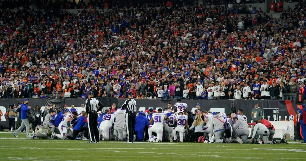 The Buffalo Bills players pray for teammate Damar Hamlin during the first half of an NFL footba ...