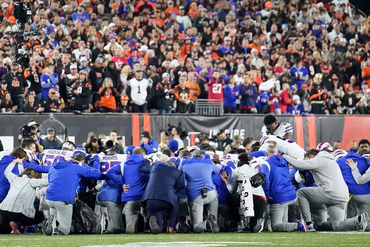 Buffalo Bills players and staff pray for Buffalo Bills' Damar Hamlin during the first half of a ...