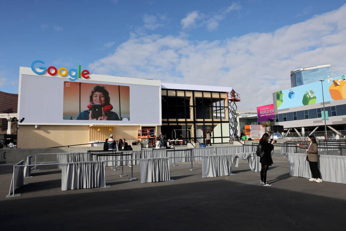 Workers build outdoor booths for CES at the Las Vegas Convention Center Tuesday, Jan. 3, 2023. ...