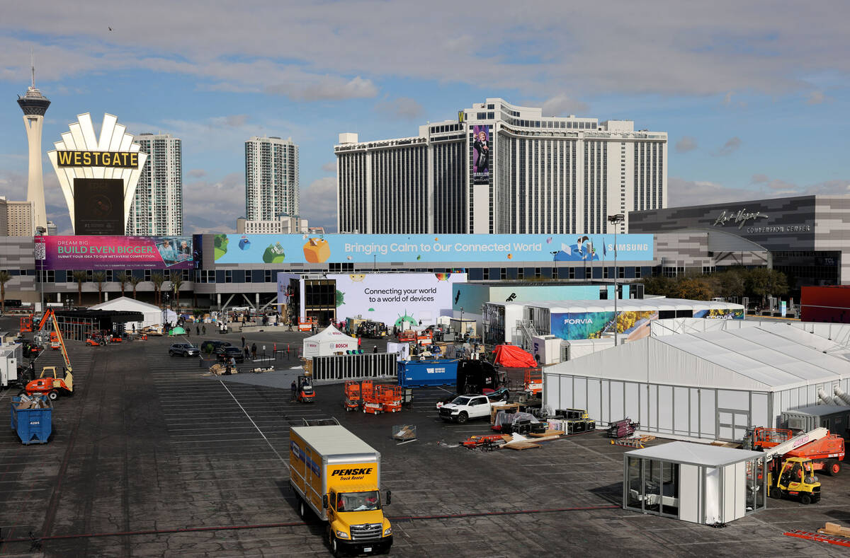 Workers build outdoor booths for CES at the Las Vegas Convention Center Tuesday, Jan. 3, 2023. ...