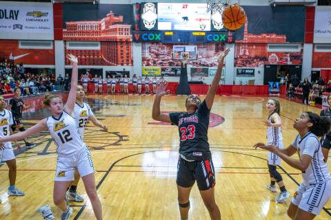 Las Vegas forward Kayla Terry (23) scores between Clark players during the first half of the N ...