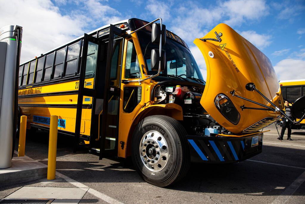 A new electric school bus acquired by the Clark County School District charges at the Arville B ...