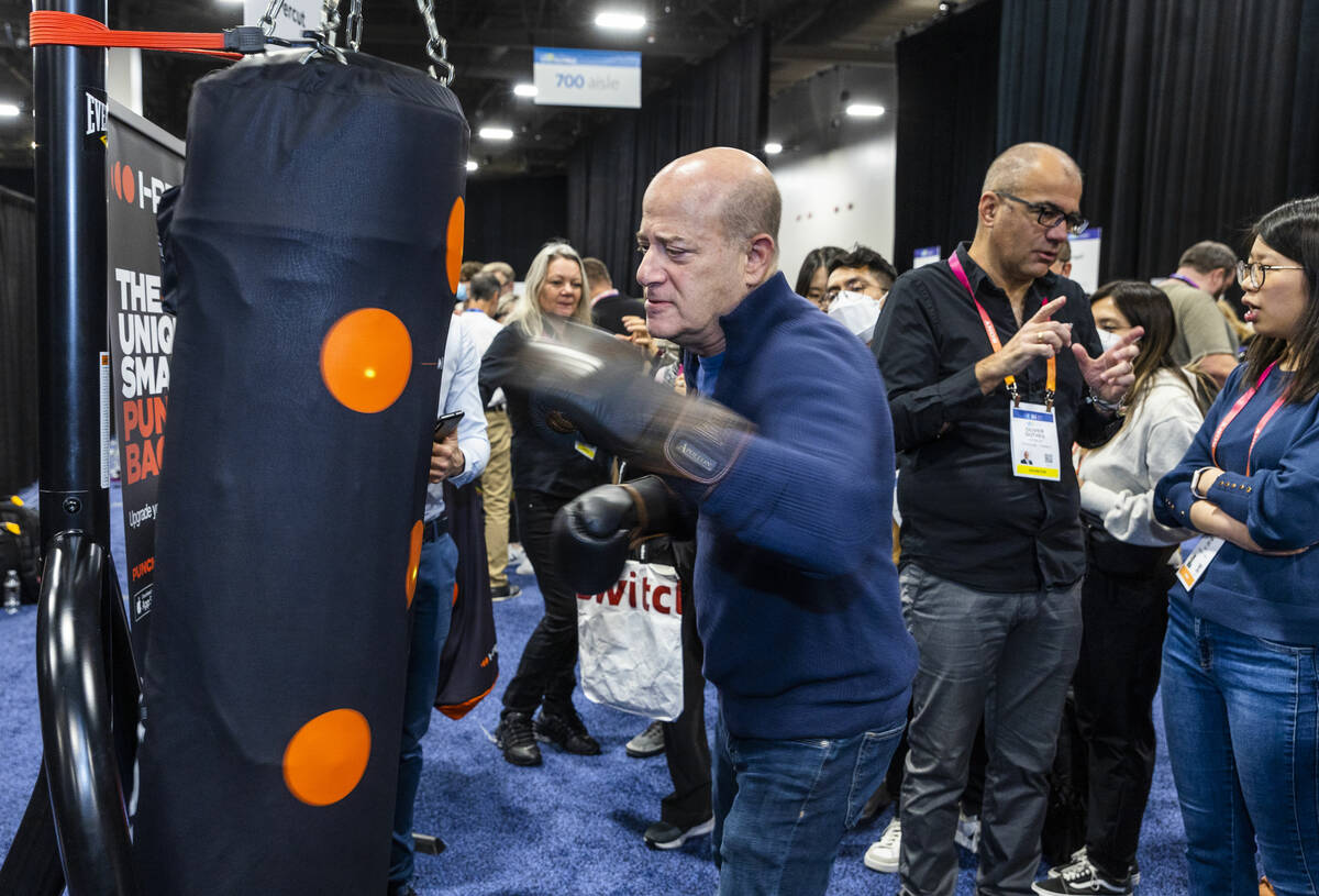 Steve Greenberg hits the I-Percut smart punching bag cover during the CES Unveiled media days e ...