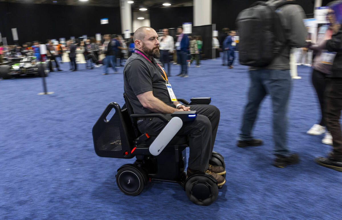 Dan Perisho with WHILL, Inc. demonstrates a power chair during the CES Unveiled media days even ...