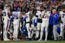 Buffalo Bills quarterback Josh Allen (17) pauses as Damar Hamlin is examined during the first h ...