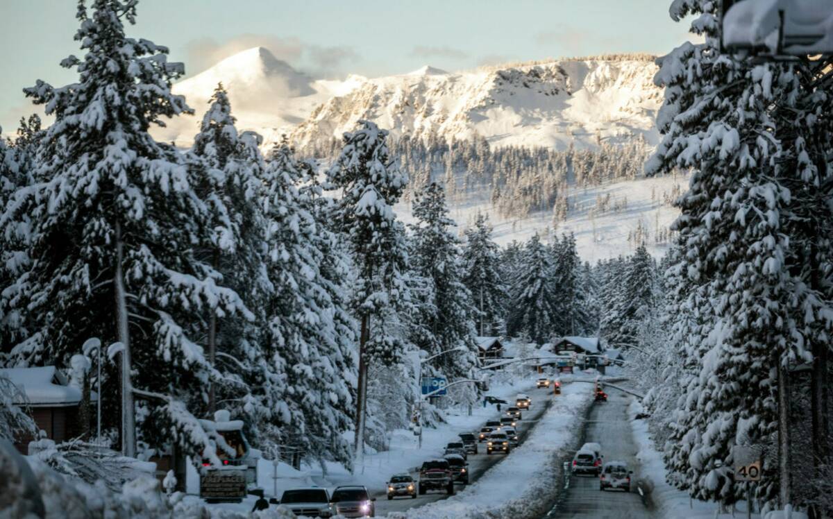 Vehicles travel along a snow-lined U.S. Route 50 the morning after a winter storm pelted the re ...