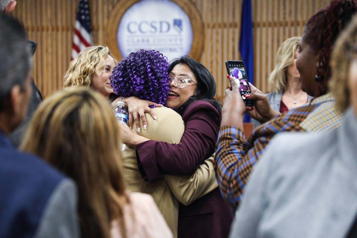 School Board Trustee Brenda Zamora hugs a supporter after a special meeting to swear in newly e ...