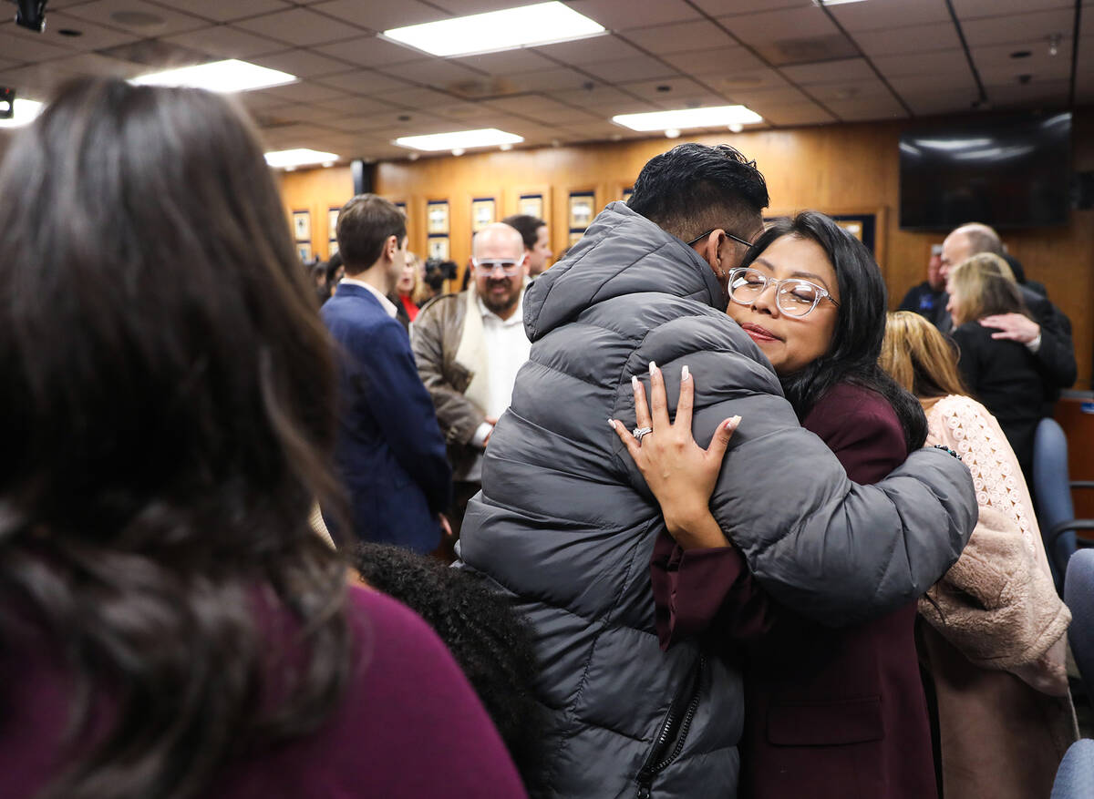 School Board Trustee Brenda Zamora hugs her brother Jair Guigui after a special meeting where s ...