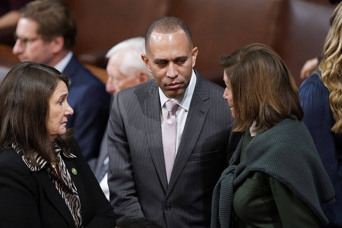 Rep. Hakeem Jeffries, D-N.Y., center, talks with Rep. Nancy Pelosi, D-Calif., in the House cham ...