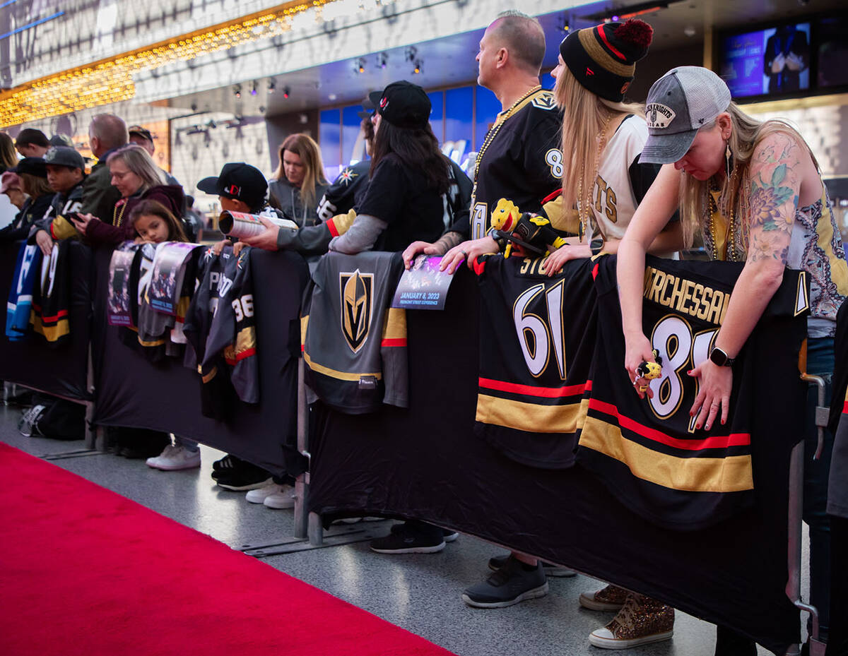 Fans prepare their gear for autographs during the Las Vegas Golden Knights Fan Fest at the Frem ...