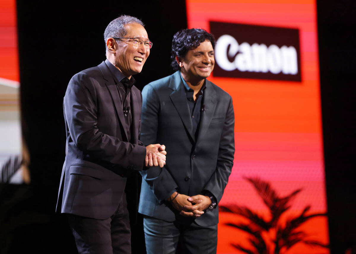 Kazuto “Kevin” Ogawa, president and CEO of Canon Americas, left, and M. Night Shy ...