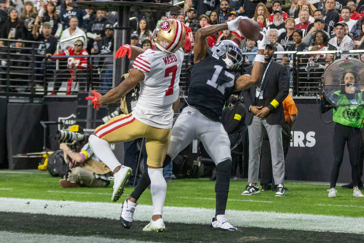 Raiders wide receiver Davante Adams (17) scores a touchdown with San Francisco 49ers cornerback ...