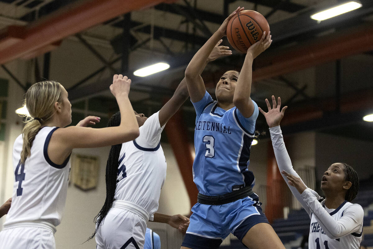 Centennial’s Charlece Ohiaeri (3) shoots against Shadow Ridge players Kelly Megown (4), ...