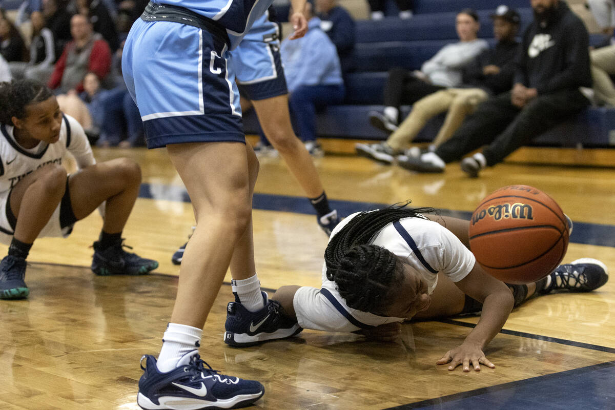 Shadow Ridge’s Hannah Hayes, right, dives for the ball during a girls high school basket ...