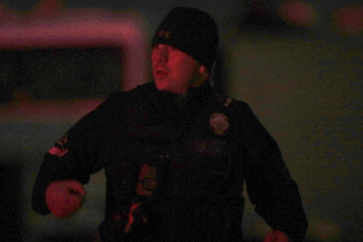 A law enforcement officer stands stands near the Enoch, Utah, home where eight family members w ...