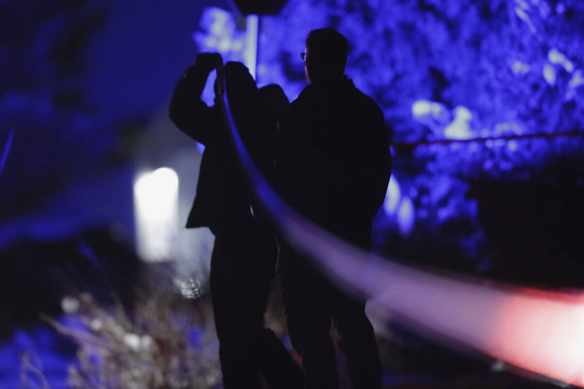 Law enforcement officials stand near the Enoch, Utah, home where eight family members were foun ...