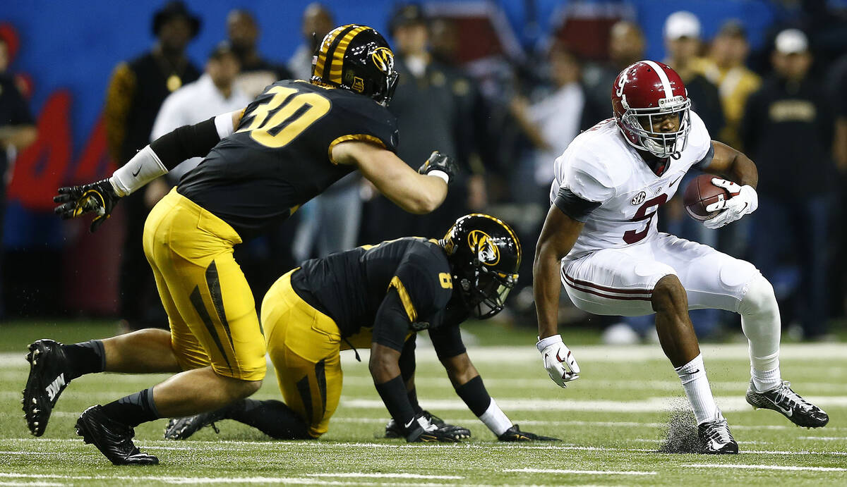 Alabama wide receiver Amari Cooper (9) runs against Missouri linebacker Michael Scherer (30) an ...