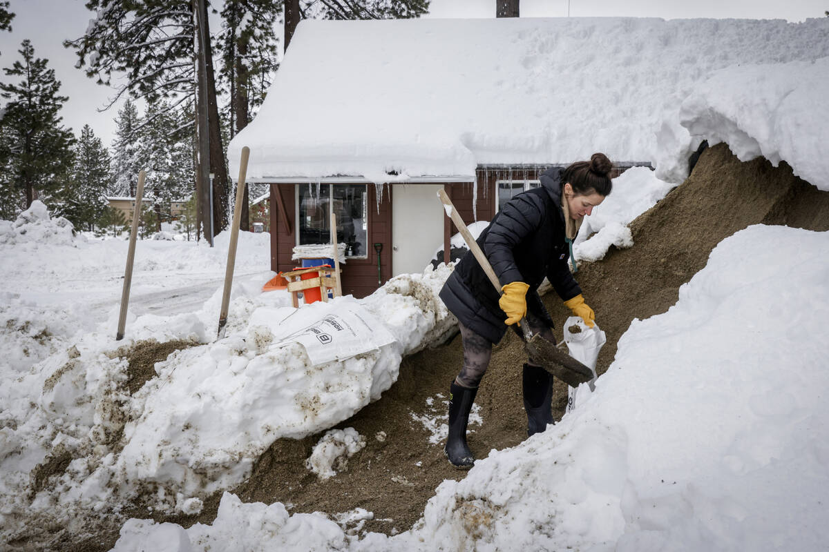 A woman, who choses to remain anonymous, fills bags of sand offered at South Lake Tahoe Fire Re ...
