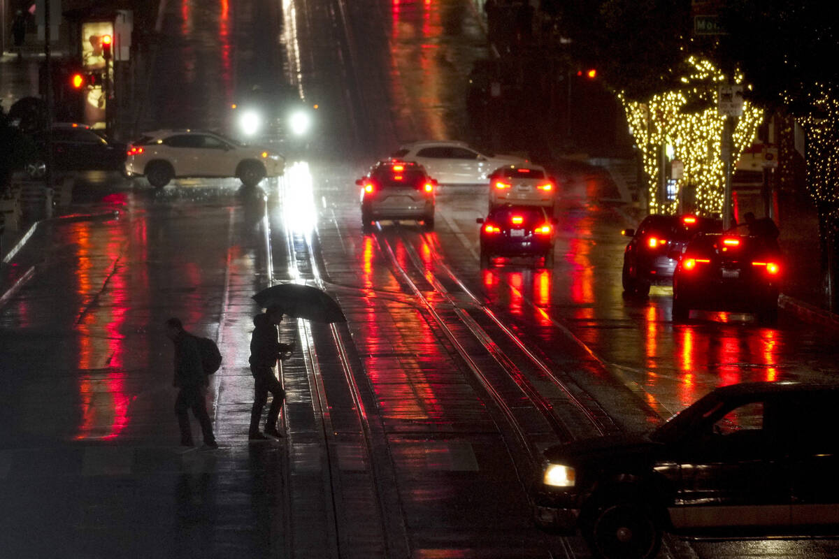 People walk across California Street in San Francisco, Wednesday, Jan. 4, 2023. Another winter ...
