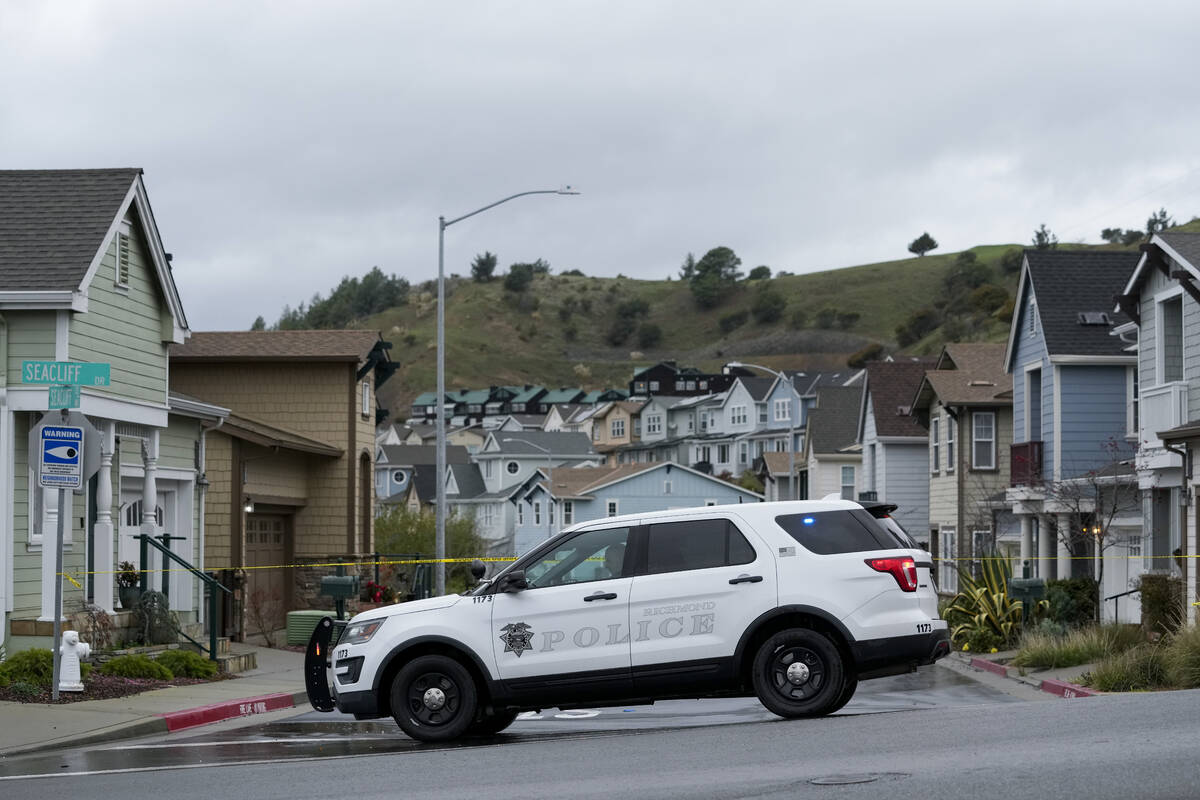 A police officer blocks a street after some residents in the Seacliff neighborhood were evacuat ...