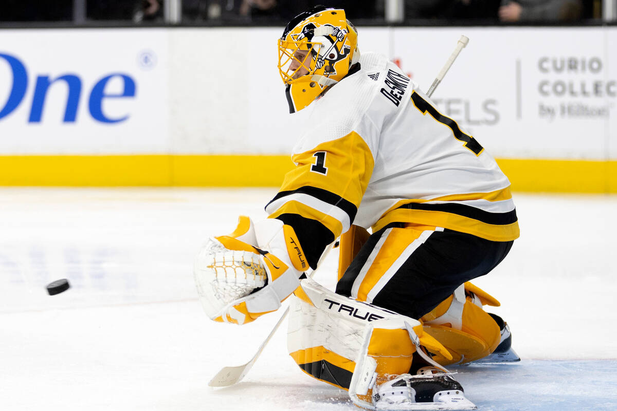 Pittsburgh Penguins goaltender Casey DeSmith prepares to glove the puck during the second perio ...
