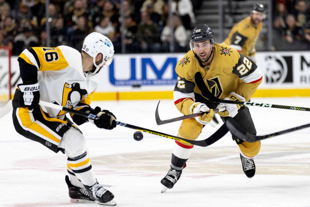 Vegas Golden Knights center Michael Amadio (22) passes the puck while Pittsburgh Penguins left ...