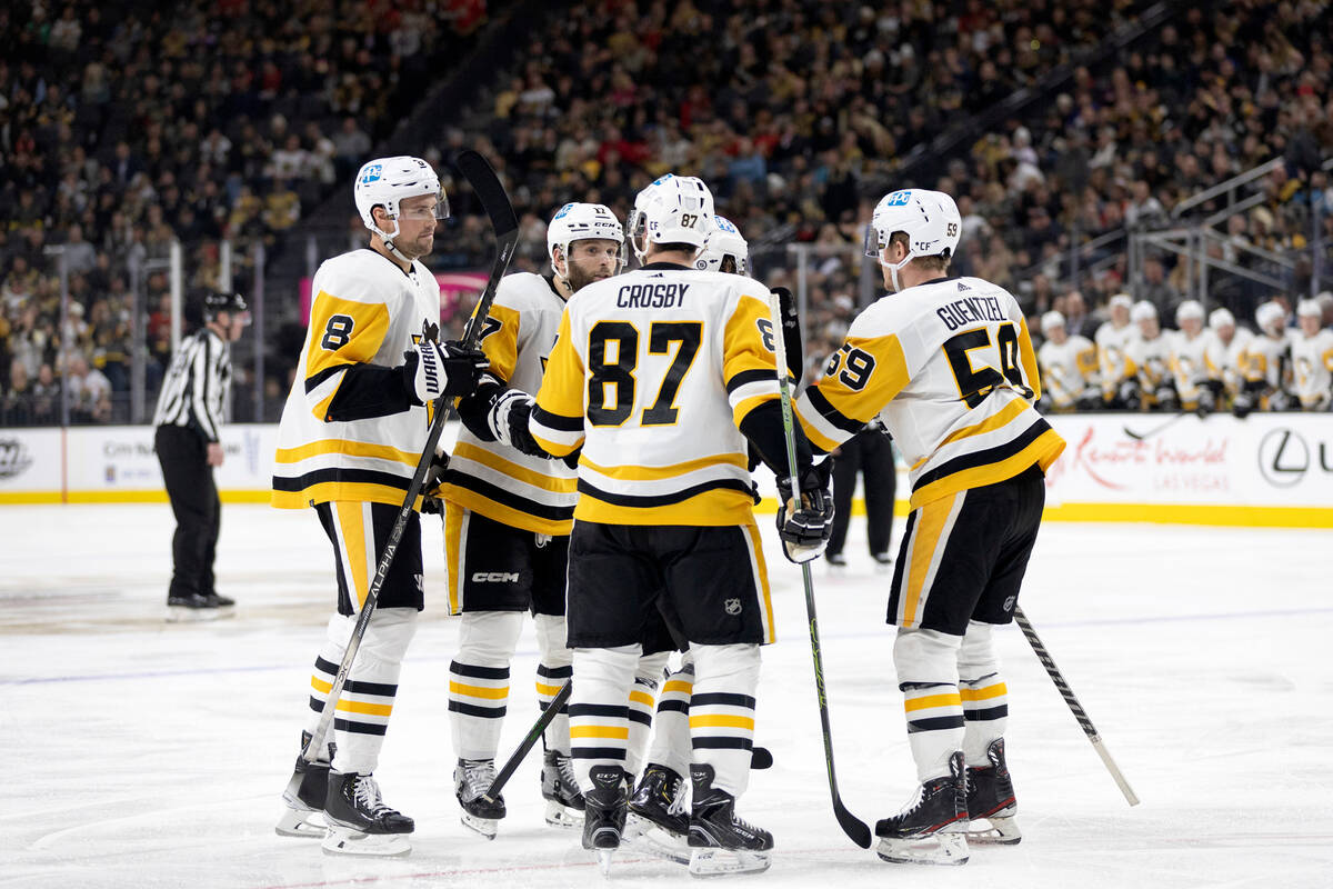 The Pittsburgh Penguins celebrate after defenseman Ty Smith scored a goal against the Vegas Gol ...