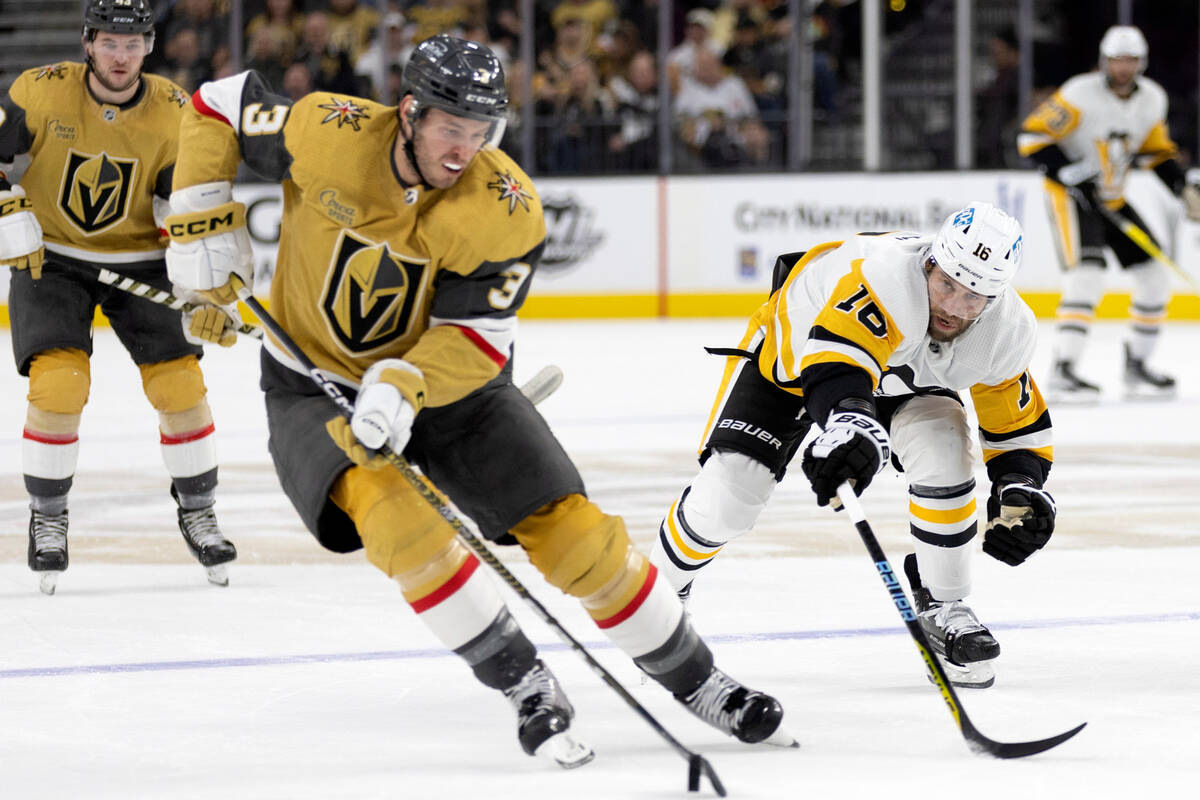 Pittsburgh Penguins left wing Jason Zucker (16) reaches for the puck as Vegas Golden Knights de ...