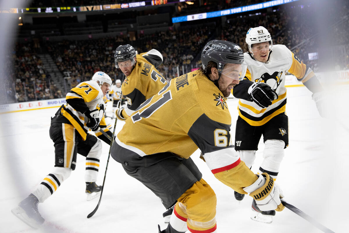 Vegas Golden Knights right wing Mark Stone (61) passes the puck while Pittsburgh Penguins righ ...