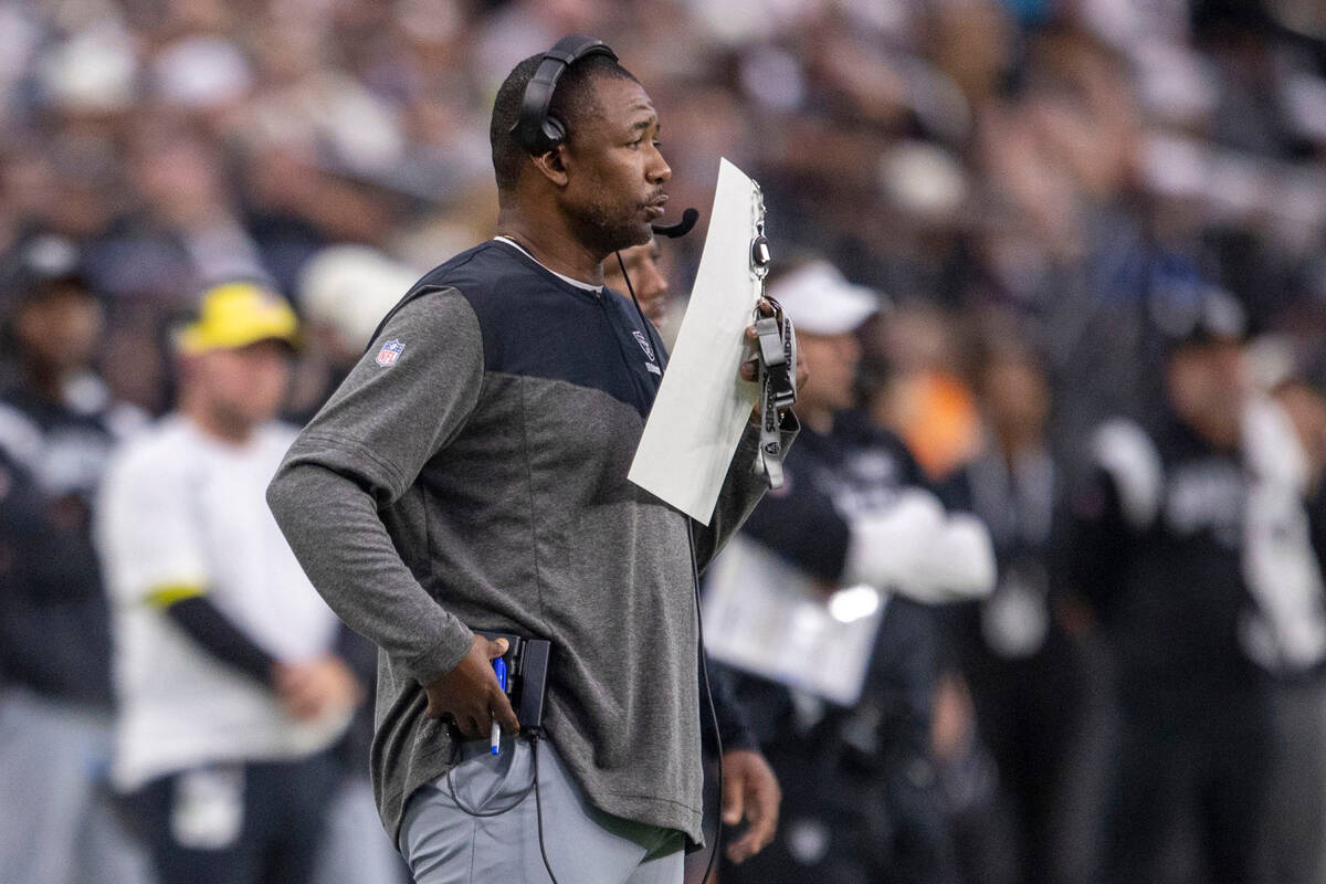 Raiders defensive coordinator Patrick Graham calls a play during the first half of an NFL game ...
